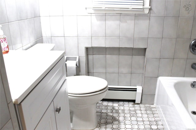 bathroom with vanity, a bath, toilet, tile walls, and a baseboard radiator