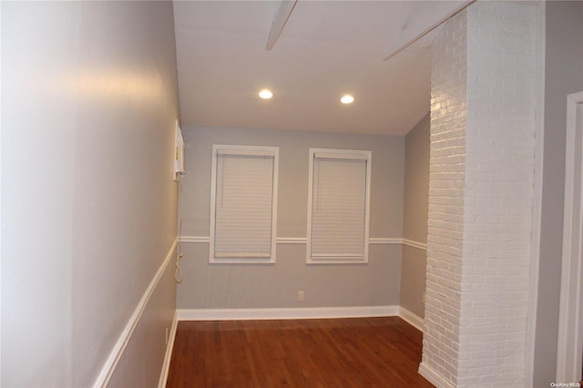 hallway with dark hardwood / wood-style flooring