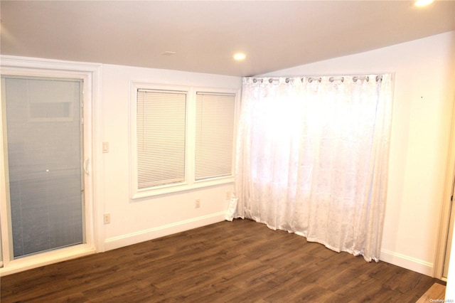 unfurnished bedroom featuring lofted ceiling and dark wood-type flooring