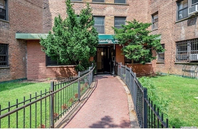 doorway to property with a lawn