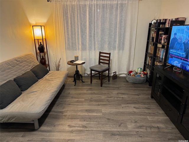 sitting room with wood-type flooring