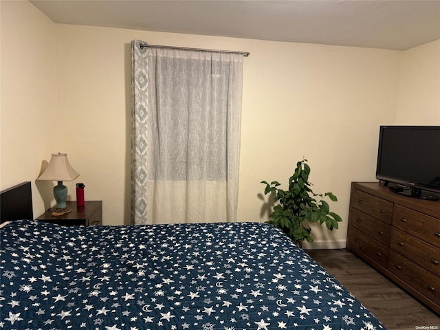 bedroom with dark wood-type flooring