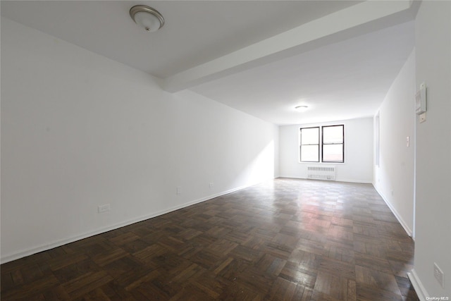 unfurnished room featuring dark parquet floors and radiator