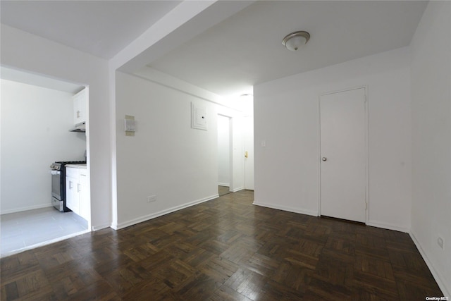 spare room featuring dark parquet floors