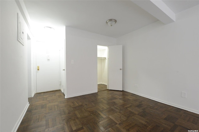 empty room with dark parquet flooring