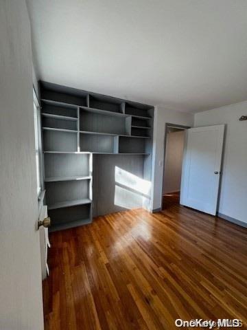 unfurnished bedroom featuring dark wood-type flooring