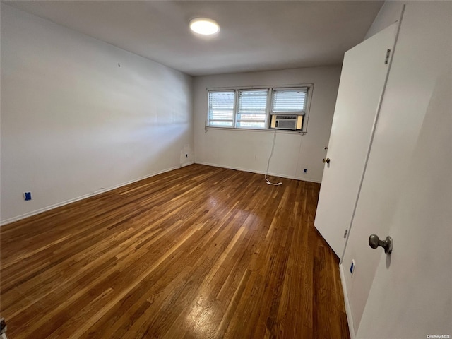 empty room with dark hardwood / wood-style floors and cooling unit