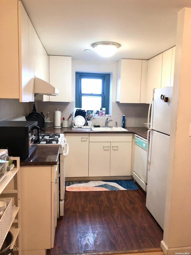 kitchen with white cabinets, dark hardwood / wood-style flooring, white appliances, and sink