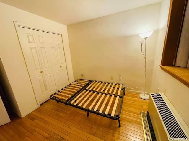 bedroom with a closet and light hardwood / wood-style flooring