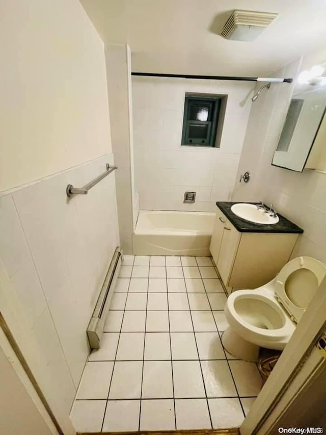 full bathroom with tiled shower / bath combo, baseboard heating, tile walls, tile patterned flooring, and toilet