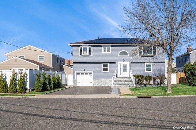 front facade featuring solar panels and a garage