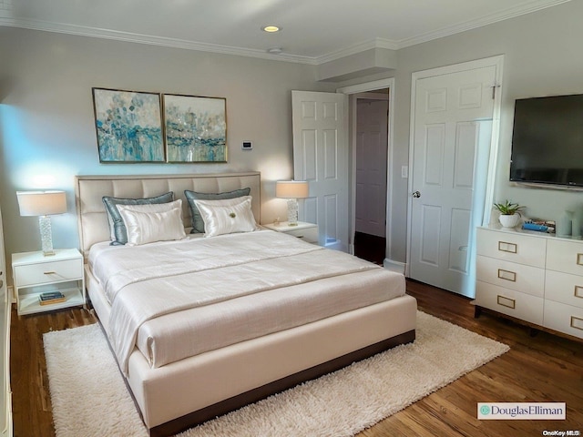 bedroom with crown molding and dark hardwood / wood-style flooring