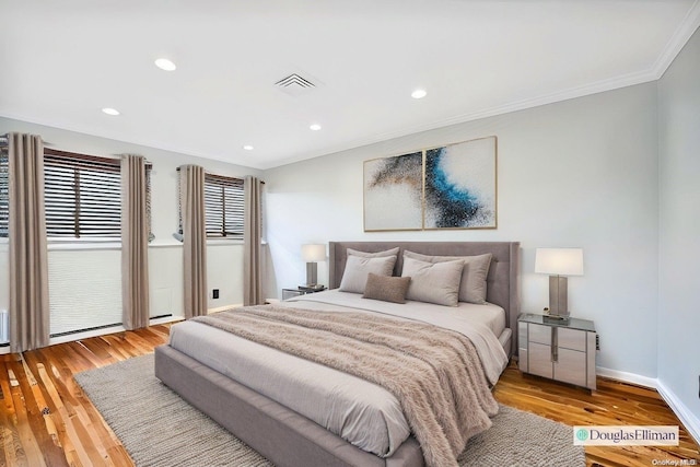 bedroom featuring light hardwood / wood-style floors and ornamental molding