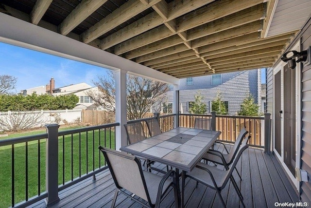 wooden deck featuring a lawn