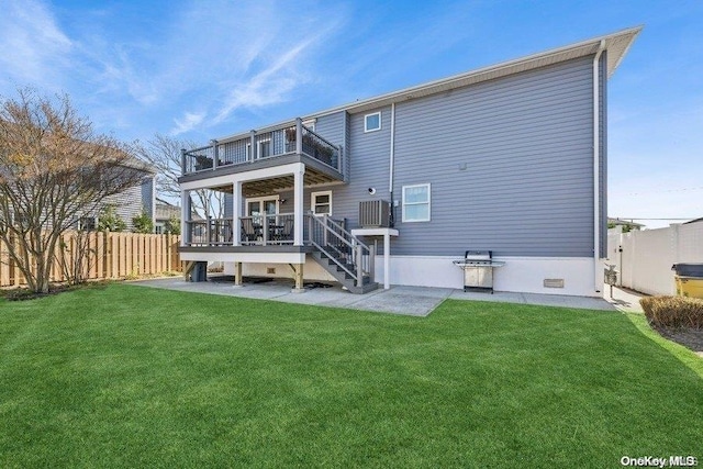 back of property featuring a lawn, a balcony, and a deck