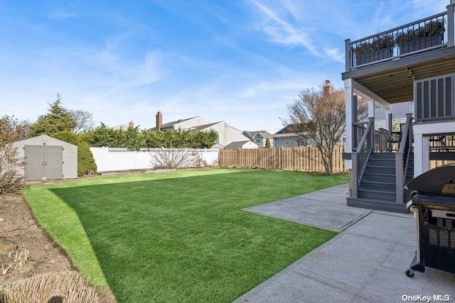 view of yard featuring a storage unit and a patio area