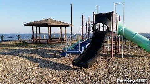 view of jungle gym featuring a water view