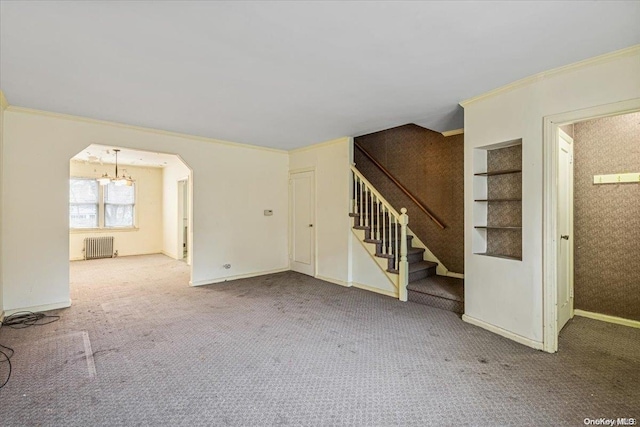 unfurnished living room with carpet flooring, radiator heating unit, and ornamental molding