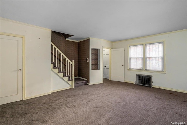 unfurnished living room featuring carpet flooring, radiator heating unit, and crown molding