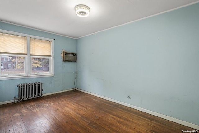 empty room featuring a wall mounted air conditioner, dark hardwood / wood-style flooring, radiator, and ornamental molding