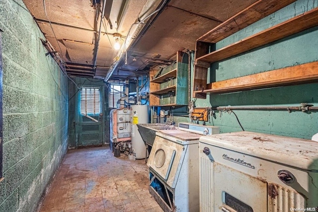 basement featuring sink, gas water heater, and washer / dryer