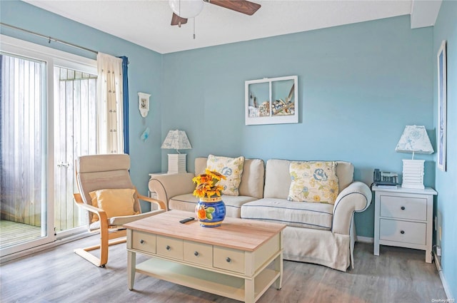 living room featuring hardwood / wood-style floors and ceiling fan