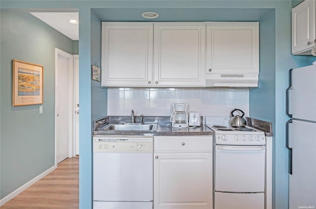 kitchen featuring white appliances, ventilation hood, white cabinets, decorative backsplash, and light wood-type flooring