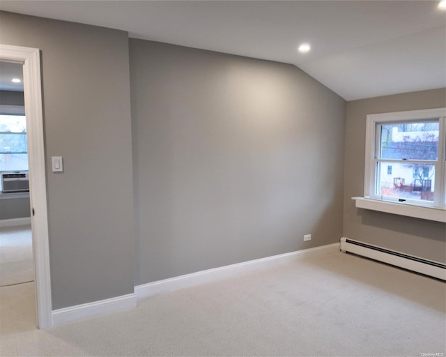 spare room with plenty of natural light, light colored carpet, lofted ceiling, and a baseboard heating unit