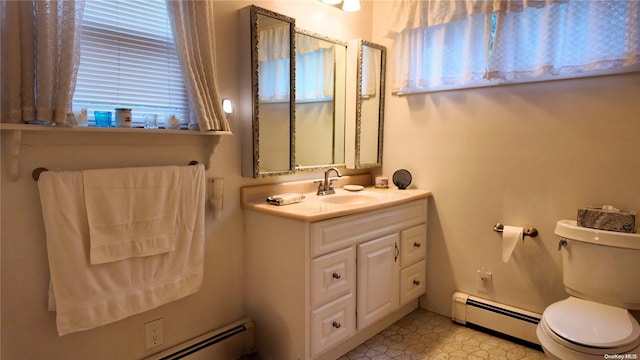 bathroom featuring toilet, vanity, and a baseboard heating unit