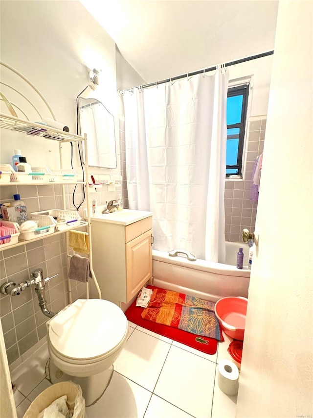 full bathroom with shower / bath combination with curtain, vanity, tile walls, tile patterned flooring, and toilet