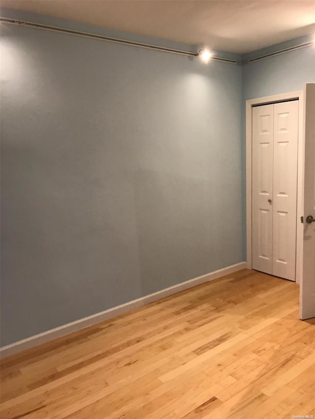 unfurnished room with light hardwood / wood-style floors