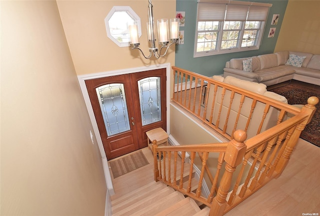 1070 Mckinley St, Baldwin, NY 11510 - entrance foyer with a chandelier, wood finished floors, baseboards, and stairs