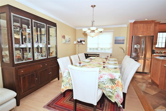 1070 Mckinley St, Baldwin, NY 11510 - dining area with a chandelier, crown molding, and light wood-type flooring