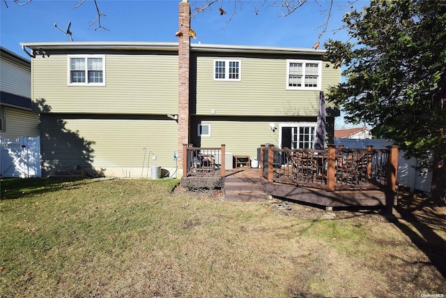 1070 Mckinley St, Baldwin, NY 11510 - back of property with a yard and a wooden deck