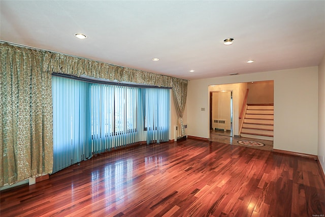 spare room featuring hardwood / wood-style floors and radiator