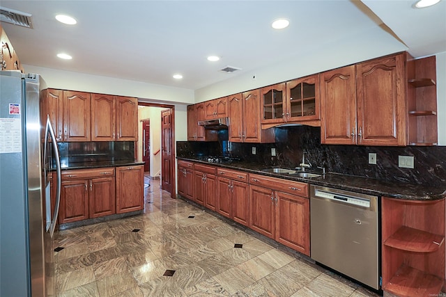 kitchen featuring decorative backsplash, dark stone countertops, sink, and appliances with stainless steel finishes