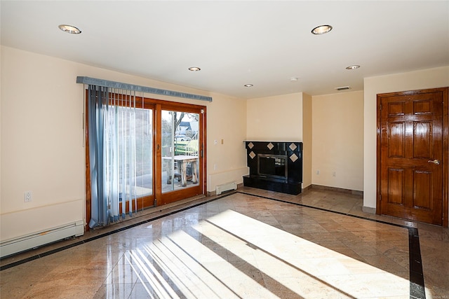 unfurnished living room with a fireplace and baseboard heating