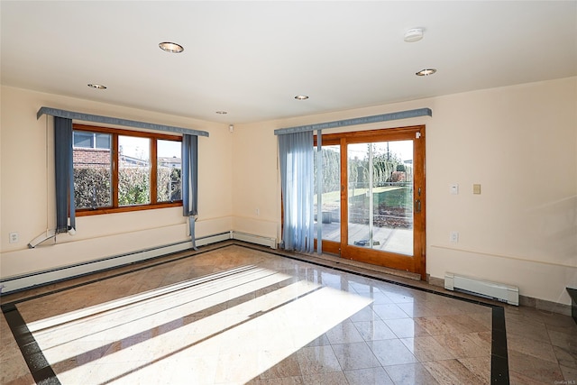 unfurnished room with plenty of natural light and a baseboard radiator