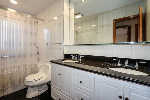 bathroom with tile patterned flooring, vanity, tile walls, and toilet