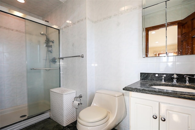 bathroom featuring a shower with door, tile walls, and toilet