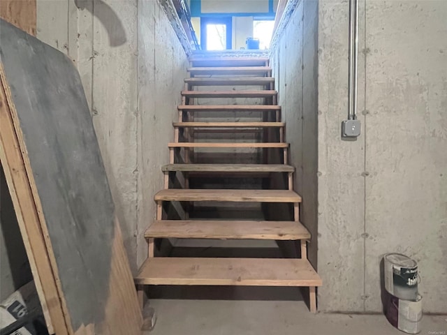 staircase with concrete flooring