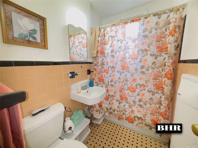 bathroom featuring sink, tile walls, tile patterned flooring, toilet, and a shower with curtain