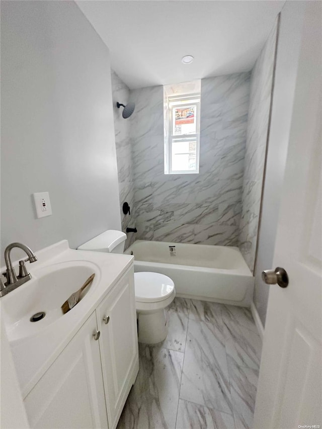 full bathroom featuring vanity, toilet, and tiled shower / bath