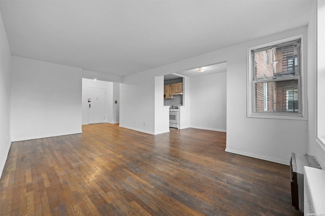 unfurnished living room with dark wood-type flooring