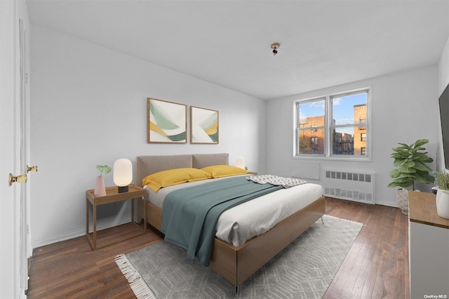 bedroom with dark hardwood / wood-style flooring and radiator heating unit