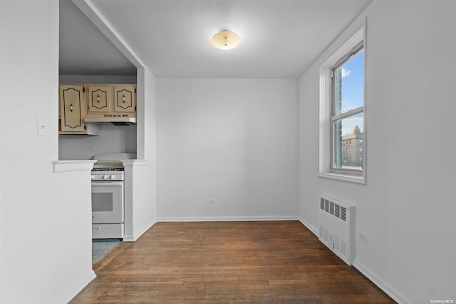 kitchen featuring radiator heating unit, white range oven, and hardwood / wood-style floors