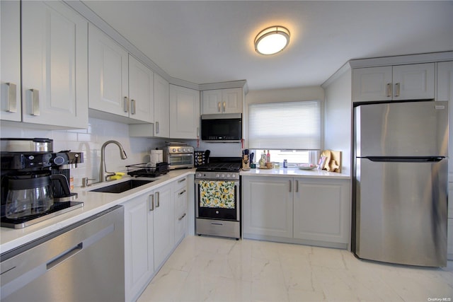 kitchen featuring backsplash, sink, and appliances with stainless steel finishes