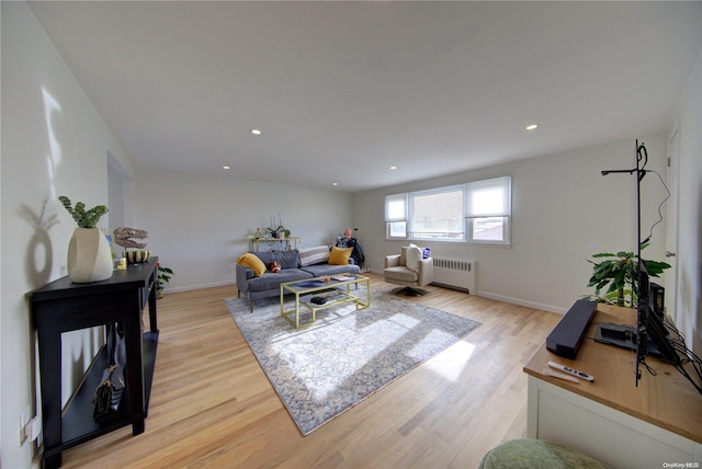 living room with radiator heating unit and light wood-type flooring