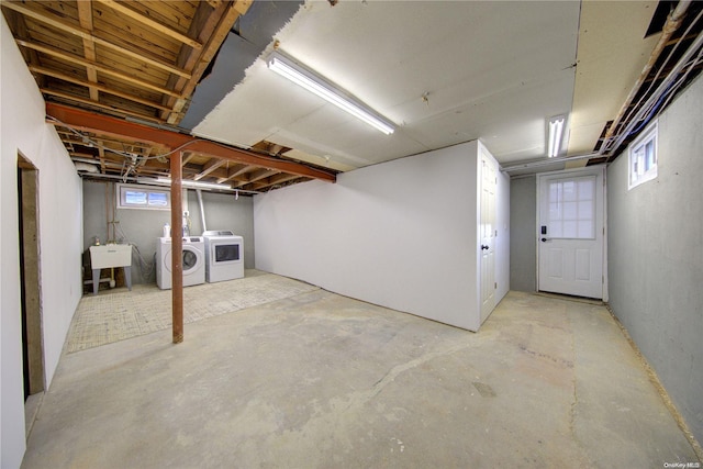 basement with washer and clothes dryer and sink