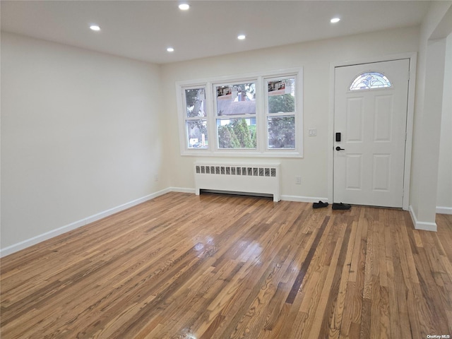 foyer featuring hardwood / wood-style flooring and radiator